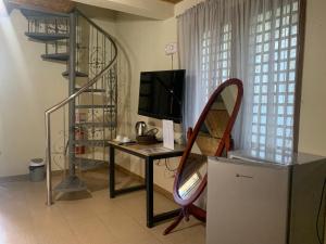 a room with a desk with a computer and a chair at Valley Breeze Resort in Gabaldon