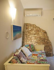 a bedroom with a bed and a stone wall at Apartments Lea in Mandre