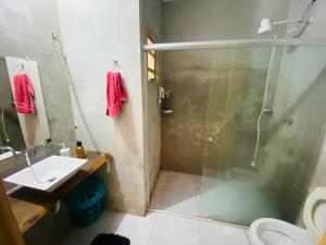 a bathroom with a shower and a sink and a toilet at Casa Completa para Hospedagem in Rosário do Sul
