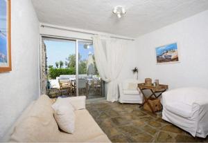 a living room with a couch and a table at Agistri House Pefkohori in Pefkochori