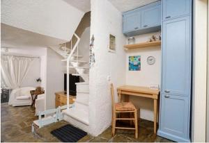 a room with a staircase and a desk and a room with a room at Agistri House Pefkohori in Pefkochori