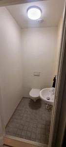 a bathroom with a white sink and a toilet at 7,3sq mts room -Forests cozy house in Stavanger