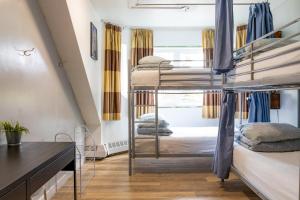 a dorm room with bunk beds and a desk at Samesun Banff Hostel in Banff