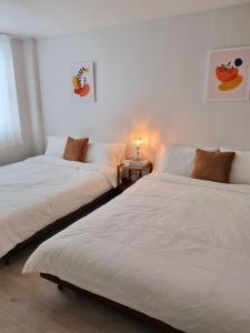 two beds sitting next to each other in a room at Wanna Stay in Suwon