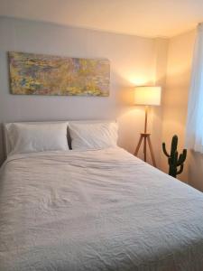 a bedroom with a white bed and a cactus at Wanna Stay in Suwon
