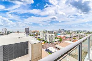 a view of a city from the balcony of a building at Stunning City Views from Modern 1BR Apartment King in Darwin +1 photo