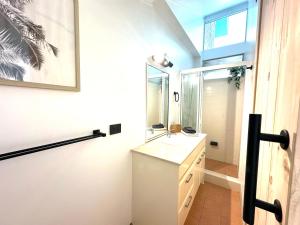 a bathroom with a sink and a mirror at 3 bedrooms with Views over Kirra! in Gold Coast +25 photos