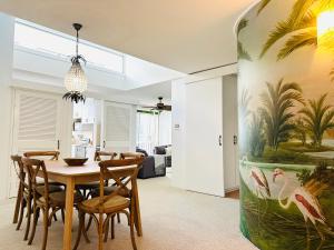 a dining room with a table and chairs at 3 bedrooms with Views over Kirra! in Gold Coast