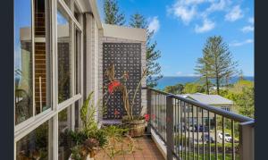 a balcony of a house with a view of the ocean at 3 bedrooms with Views over Kirra! in Gold Coast