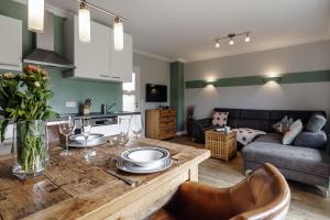 a living room with a table with plates on it at LITZKOW 11101 in Morsum