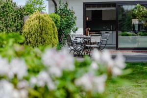 a patio with chairs and a table in a yard at LITZKOW 11101 in Morsum