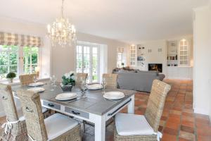 a dining room and living room with a table and chairs at LITZKOW 12802 in Morsum