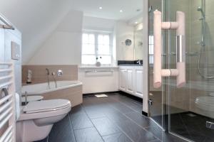 a bathroom with a toilet and a shower and a sink at LITZKOW 12802 in Morsum +15 photos