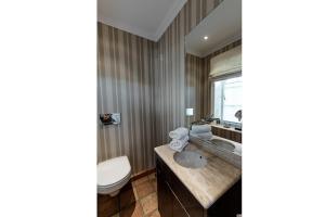 a bathroom with a toilet and a sink at LITZKOW 15808 in Morsum +13 photos