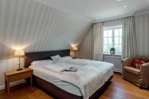 a bedroom with a large bed and a couch at LITZKOW 15808 in Morsum
