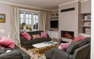 a living room with two couches and a fireplace at LITZKOW 12806 in Westerwall