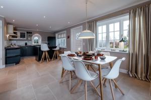 a kitchen and living room with a white table and chairs at LITZKOW 12806 in Westerwall