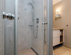 a bathroom with a shower with a glass door at LITZKOW 12806 in Westerwall +13 photos