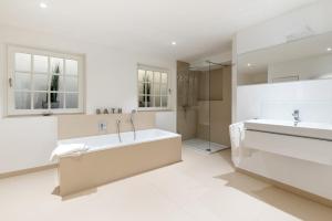 a bathroom with a tub and a shower and a sink at LITZKOW 14205 in Morsum +20 photos