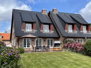 una casa con una fila di tetti neri di LITZKOW 12503 a Morsum