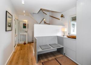 a room with a staircase with a white wall at LITZKOW 19201 in Keitum