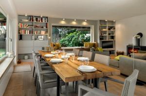 a dining room and living room with a table and chairs at LITZKOW 19201 in Keitum