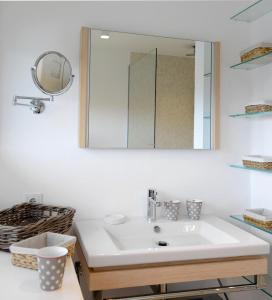 a bathroom with a sink and a mirror at LITZKOW 19201 in Keitum +17 photos
