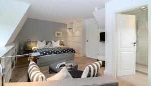 a bedroom with a bed and a living room at LITZKOW 19201 in Keitum
