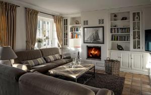 a living room with a couch and a fireplace at LITZKOW 15001 in Morsum