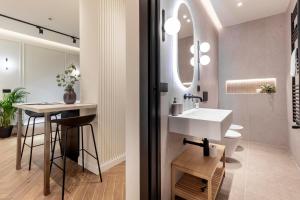 a bathroom with a sink and a counter with a table at Lungolago Modern FD Apartments in Como