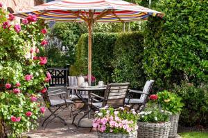 a patio with a table and chairs under an umbrella at LITZKOW 15001 in Morsum