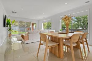 a dining room with a table and chairs at Mountain Vista Retreat - Comfort Meets Style in Lake Albert