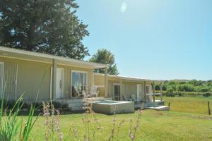 a house with a garden in front of it at Cabañas Titina's Lake in Potrero de Garay