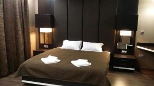 a bedroom with a bed with two towels on it at Studio Mountain Dreams Deluxe in Sapareva Banya