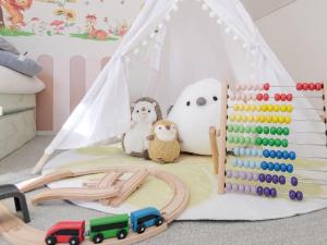 a childs play area with a toy tent and abacus at Pension Himawari in Iizuna
