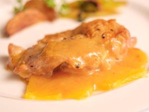 a white plate with a piece of food with sauce at Pension Himawari in Iizuna