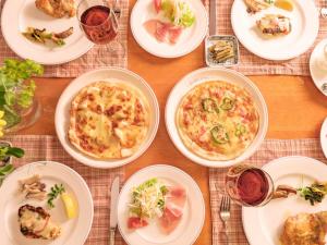 a table with plates of food on a table at Pension Himawari in Iizuna