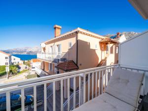 a balcony with a couch and a view of the ocean at Apartments Senjo - One Bedroom Apartment with Balcony and Sea View 4 adults Apartman 3 in Cavtat