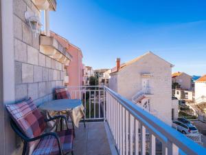 a balcony with a table and chairs on a building at Apartments Senjo - One Bedroom Apartment with Balcony with Sea View Apartman 1 in Cavtat