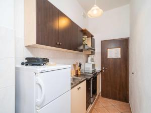 a small kitchen with a dishwasher and a washer at Apartments Senjo - Studio Apartment with Balcony with Side Sea View Apartman 4 in Cavtat +6 photos