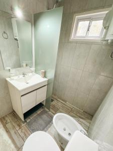 a bathroom with a sink and a toilet and a mirror at Cabañas Titina's Lake in Potrero de Garay +32 photos