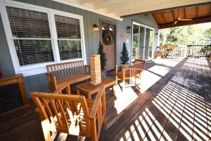 a porch with a table and chairs on a house at Ledge House-Lake Area in Bass Lake +10 photos