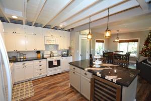 a kitchen with white cabinets and a christmas tree in it at Ledge House-Lake Area in Bass Lake