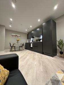 a living room with a couch and a table at Luxury City Centre Loft in Birmingham