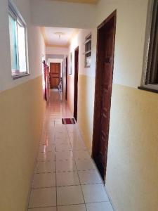 an empty hallway of a room with a tile floor at RoseMarAzul Temporadas in Cabo Frio