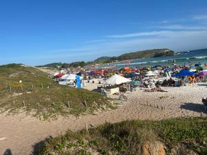 a crowd of people on a beach near the ocean at RoseMarAzul Temporadas in Cabo Frio