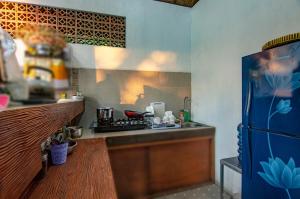 a kitchen with a stove and a counter top at Ubud 3-bedrooms with sunset view in Ubud