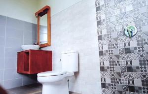 a bathroom with a toilet and a mirror at Ubud 3-bedrooms with sunset view in Ubud +20 photos