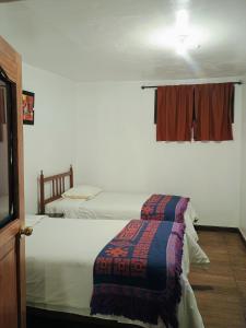 Postel nebo postele na pokoji v ubytování Posada Catama INN