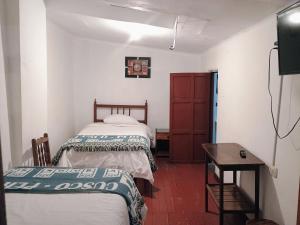 Postel nebo postele na pokoji v ubytování Posada Catama INN